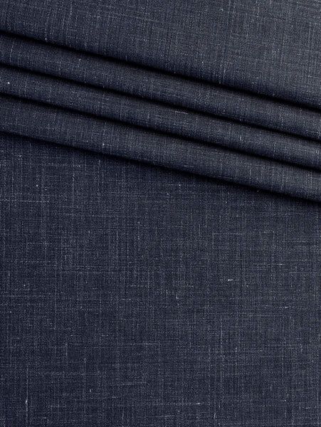 Close-up of dark charcoal fabric with layered folds and a fine weave